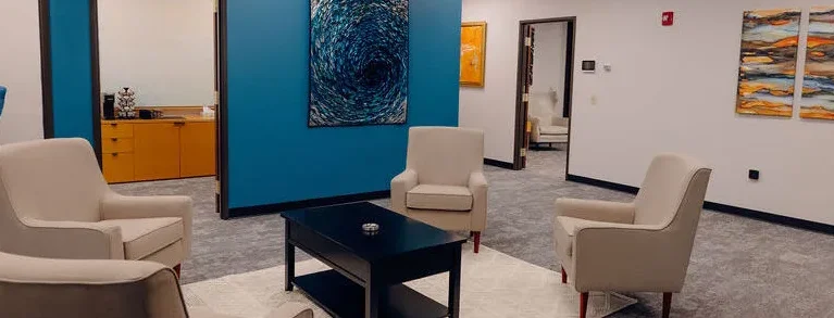 A large office environment characterized by blue walls and blue chairs, reflecting a stylish and professional setting.