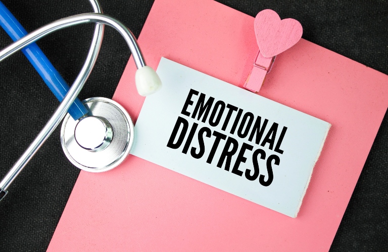 stethoscope and book with words emotional distress