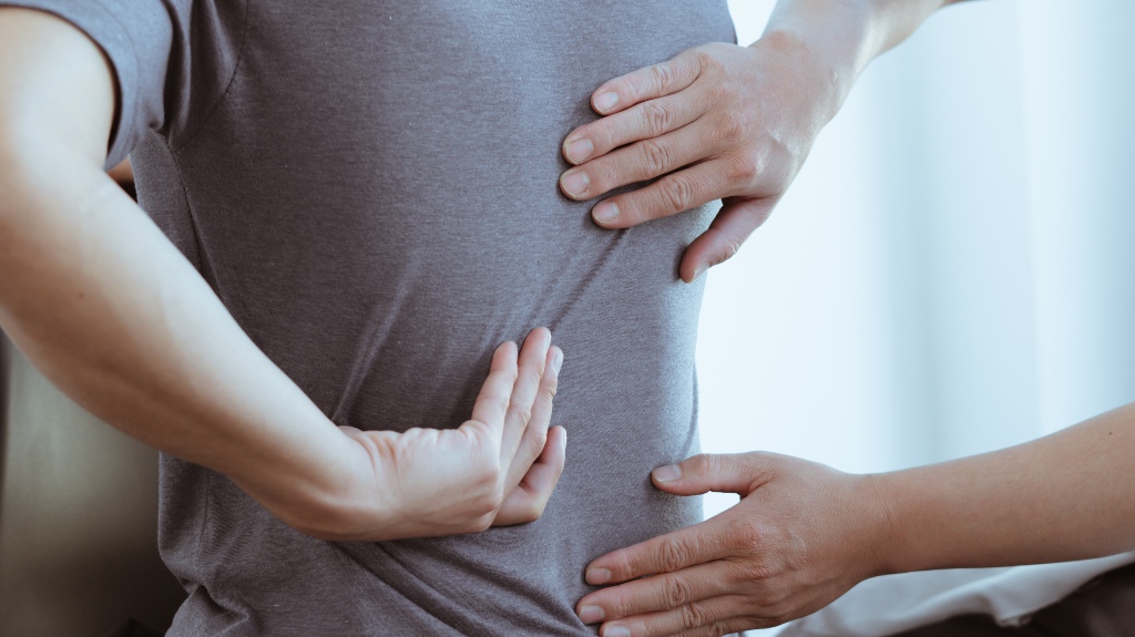 doctor examines back pain and spinal area